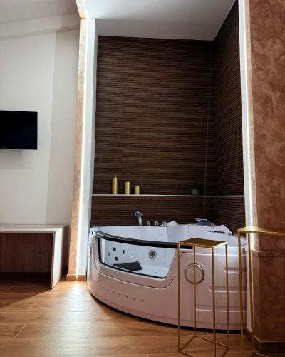 a bathroom with a tub with a large window at Relais San Giovanni srls in Castellaneta