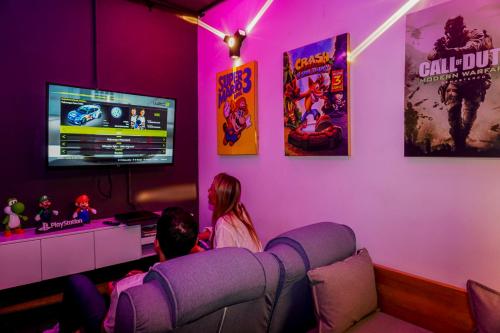 a boy and a girl playing a video game in a living room at Los Patios Cool Living in Medellín