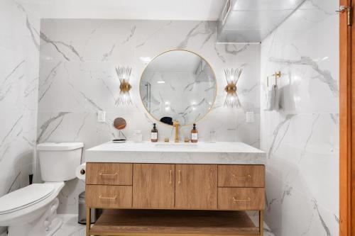 a bathroom with a sink and a mirror at Urban Oasis with Cedar Hot Tub in Seattle
