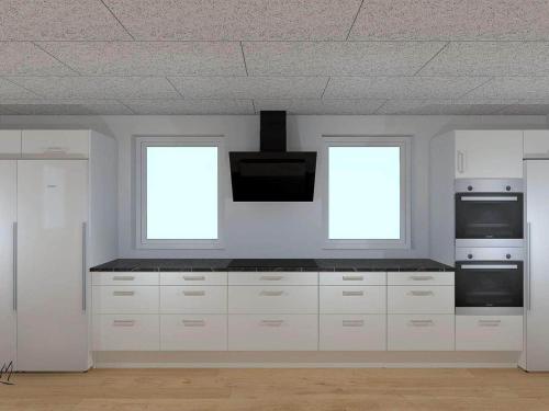 a kitchen with white cabinets and two windows at 5 star holiday home in Højslev in Højslev