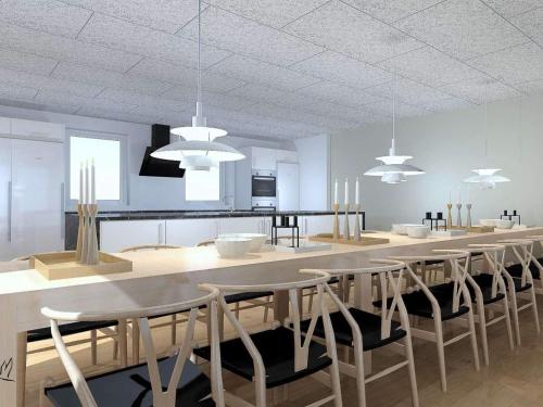 a dining room with a long table and chairs at 5 star holiday home in Højslev in Højslev