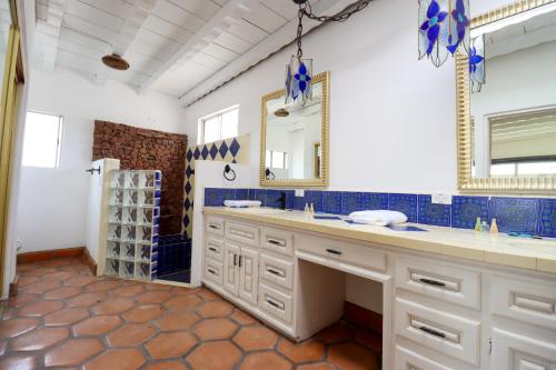 a bathroom with a double sink and a shower at Castillos Del Mar in Rosarito