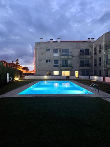 a large swimming pool in front of a building at Refúgio Suave Mar in Esposende