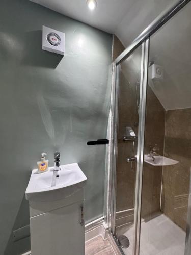 a bathroom with a shower and a sink at Cottage 33 in Kirkby Stephen
