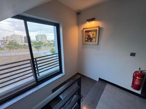 a room with a bench and a large window at Bridge Residency-2 Top City-1 Islamabad in Islamabad