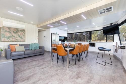 a kitchen and living room with a table and chairs at All Seasons Houseboats in Mildura