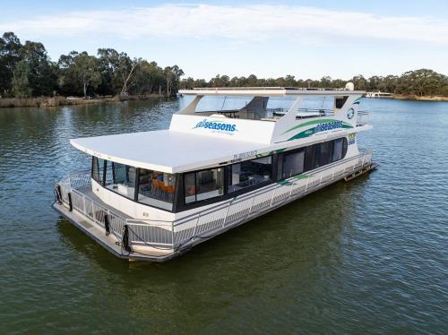 a ferry boat in the water on a river at All Seasons Houseboats in Mildura