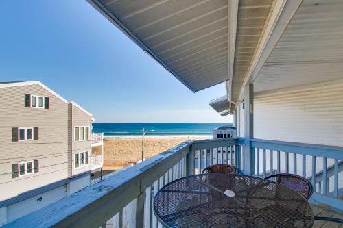 a balcony with a table and chairs and the beach at Beachfront Old Orchard Beach Condo with Balcony in Old Orchard Beach