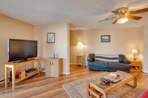a living room with a couch and a flat screen tv at Beachfront Old Orchard Beach Condo with Balcony in Old Orchard Beach