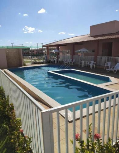 a swimming pool with a white fence around it at Ap Morada Nova in Petrolina