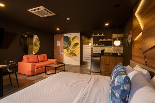 a hotel room with a bed and a kitchen at Los Patios Cool Living in Medellín