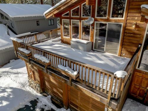 a deck of a log cabin in the snow at Handcrafted Tahoe Retreat Walk to Beach & Ski in Tahoe City