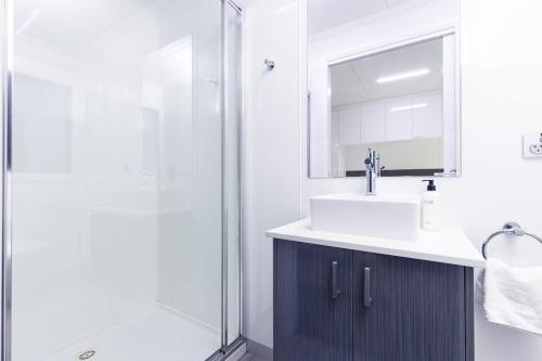 a bathroom with a sink and a shower at All Seasons Houseboats in Mildura