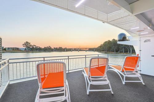 two chairs sitting on the deck of a boat at All Seasons Houseboats in Mildura