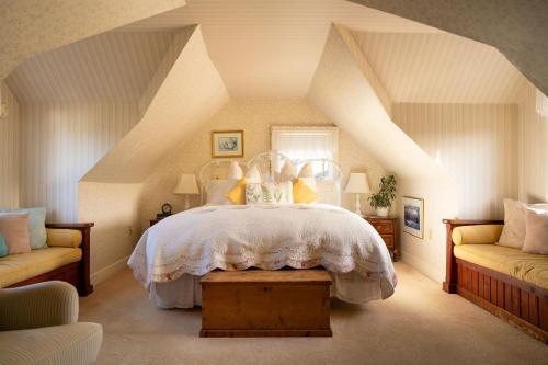 a bedroom with a large bed in a attic at Headlands Inn Bed and Breakfast in Mendocino