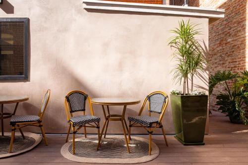 a patio with a table and chairs and a plant at The Beau Hotel Downtown San Diego Gaslamp Quarter in San Diego