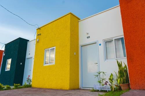a yellow and white building with doors and windows at Casa Oriente in San Miguel