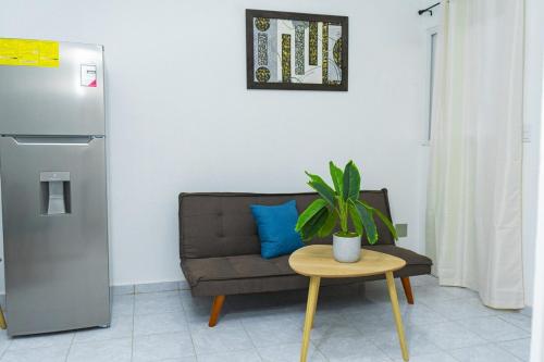 a living room with a couch and a table with a plant at Casa Oriente in San Miguel