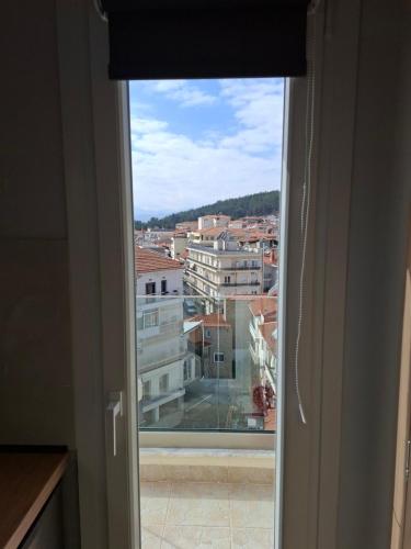 an open window with a view of a city at Kozani room with a view! in Kozani