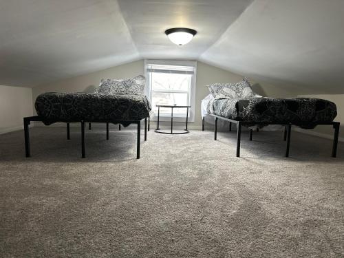 a room with two chairs and a bed and a window at Our modern tiny home in Terre Haute