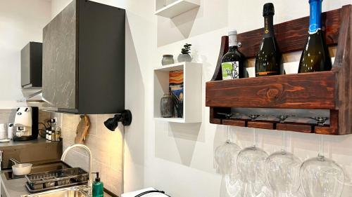a kitchen with wine glasses on a wall at SILVIO'S Apartment in Castellammare del Golfo