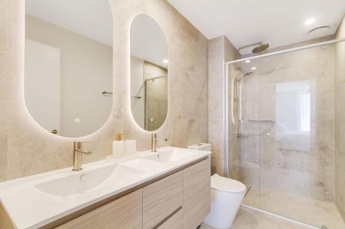 a bathroom with a sink and a toilet and a mirror at Sol 803 in Gold Coast