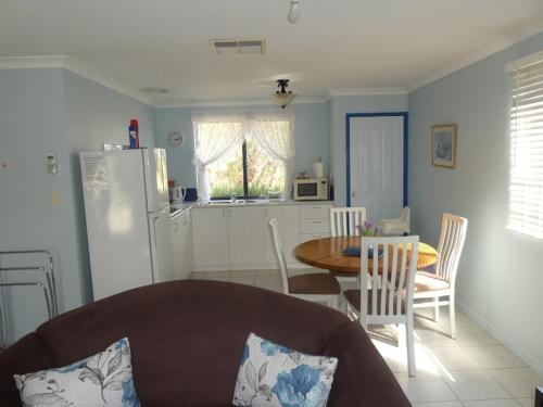 a kitchen and dining room with a table and a refrigerator at Lavendale Country Retreat in York