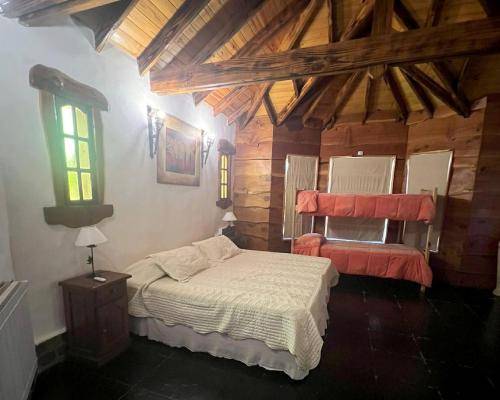 a bedroom with a bed in a room with wooden ceilings at casa alquiler mar del plata Cabaña Acantilados MDQ in Mar del Plata