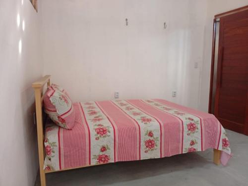 a bedroom with a bed with a pink and white blanket at Casa de Praia - Icapui - Ce - Praia de Requenguela in Icapuí