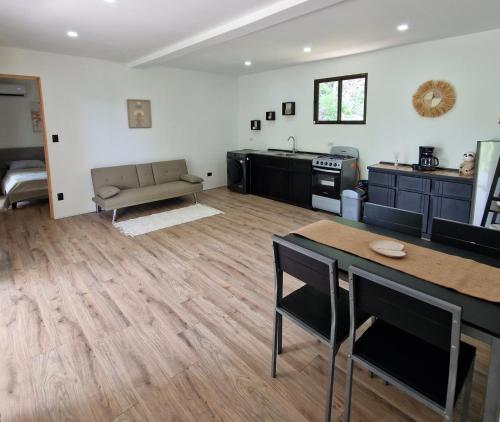 a living room with a couch and a table at Cozy houses near a beach in Puntarenas