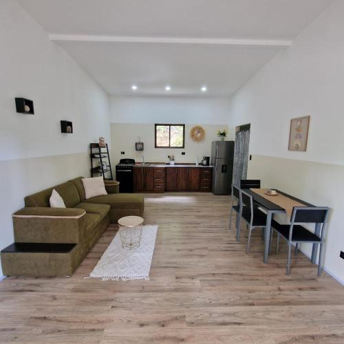 a living room with a couch and a table at Cozy houses near a beach in Puntarenas