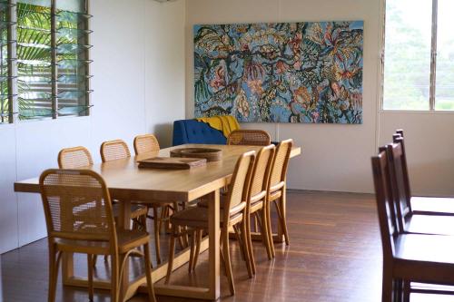 a dining room with a wooden table and chairs at Rosecliffe Farm Cottages in Pomona