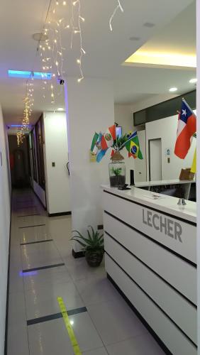 an office lobby with a reception counter and lights at hostal lecher in Iquique
