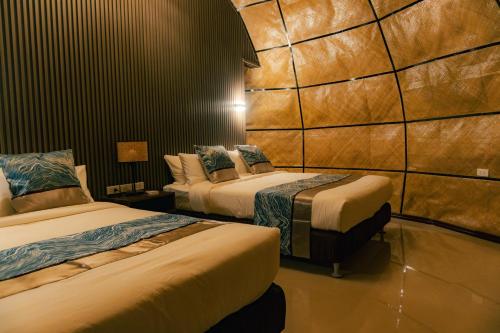 a room with two beds in a hotel room at The Dome Hotel Puerto Princesa City in Puerto Princesa City