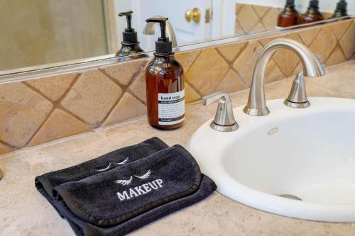 a bathroom counter with a sink and a bottle of marmite soap at Cozy Home with Pool and Jacuzzi Minutes from Universal Studios in Los Angeles