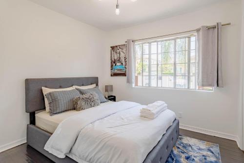 a bedroom with a large bed and a window at Cozy Home with Pool and Jacuzzi Minutes from Universal Studios in Los Angeles
