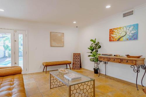 a living room with a couch and a table at Cozy Home with Pool and Jacuzzi Minutes from Universal Studios in Los Angeles
