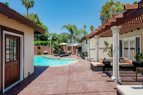 a house with a swimming pool in a yard at Cozy Home with Pool and Jacuzzi Minutes from Universal Studios in Los Angeles