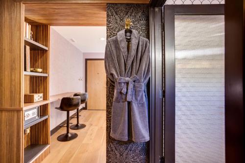 a robe hanging on a wall in a room at The Salome - ADA Accessible at The Louie Boutique Motel, Walk to Everything! Dog Friendly! in Newport