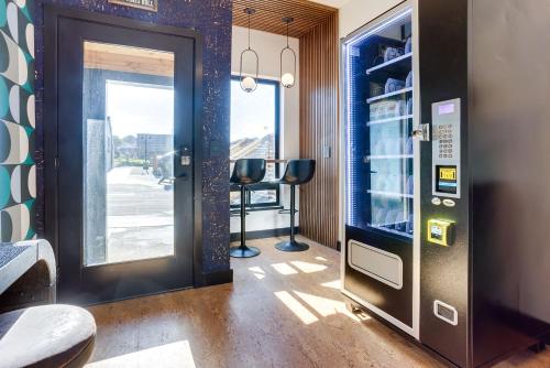 a vending machine in a room with a door at The Salome - ADA Accessible at The Louie Boutique Motel, Walk to Everything! Dog Friendly! in Newport