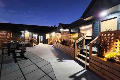 a patio of a house at night with lights at The Salome - ADA Accessible at The Louie Boutique Motel, Walk to Everything! Dog Friendly! in Newport