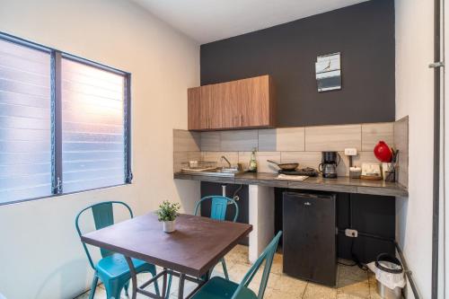 a kitchen with a table and chairs in a room at Apart-Hotel "El Lago" in Guatemala