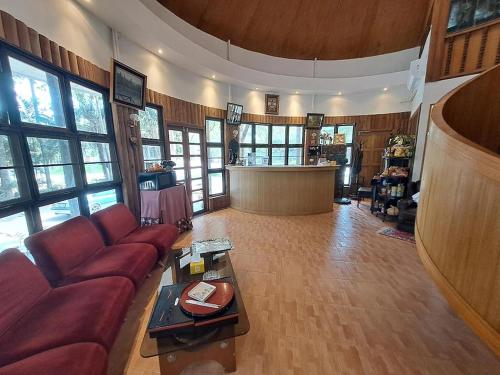 a living room with a couch and a table at Nomads Homestay Sriracha in Chon Buri