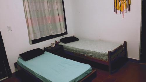 een kamer met 2 aparte bedden in een kamer bij Sol de la cumbre in La Cumbre