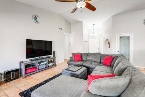 a living room with a couch and a flat screen tv at 3 Mi to Dtwn Home with Heated Pool in Gilbert in Gilbert