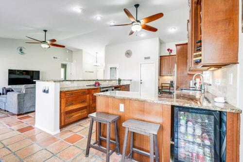 a kitchen with a center island with bar stools at 3 Mi to Dtwn Home with Heated Pool in Gilbert in Gilbert