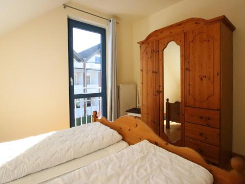 a bedroom with a bed and a dresser and a mirror at Ferienwohnung in Burhave in Burhave