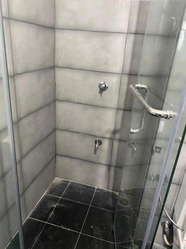 a bathroom with a shower with a glass door at Oval View Residencies in Yakbedda