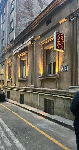 a building with a sign on the side of a street at Hotel Forever in Belgrade