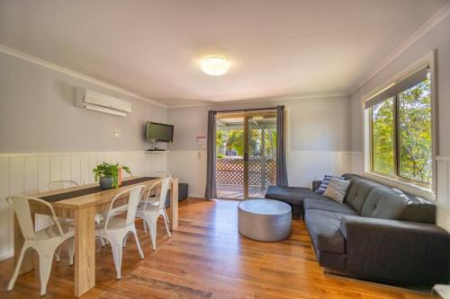 a living room with a couch and a table at Ingenia Holidays One Mile Beach in One Mile